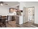Modern kitchen features stainless steel appliances, light wood cabinets, and a breakfast bar, with an adjacent dining area at 8225 Fairmount Dr # 10-204, Denver, CO 80247