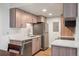 Modern kitchen featuring stainless steel appliances, wood cabinets, and marble countertops at 8225 Fairmount Dr # 10-204, Denver, CO 80247