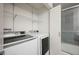 Well-organized laundry room with modern washer and dryer and convenient storage shelves at 8225 Fairmount Dr # 10-204, Denver, CO 80247