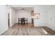Bright living room adjacent to a modern kitchen featuring an adjacent dining area, and front door at 8225 Fairmount Dr # 10-204, Denver, CO 80247