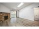 Bright living room featuring wood floors, stone fireplace, and sliding door to the patio at 8225 Fairmount Dr # 10-204, Denver, CO 80247