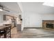 Open living space with modern kitchen, fireplace, wood floors, and bright lighting at 8225 Fairmount Dr # 10-204, Denver, CO 80247