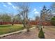 Backyard space with grass and rock landscaping with a privacy fence at 65 Reed St, Lakewood, CO 80226