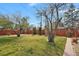 Large, well-maintained backyard featuring a lawn and a tall wooden fence at 65 Reed St, Lakewood, CO 80226