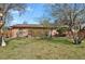 A well-maintained backyard, showing lawn, a brick home, and a privacy fence at 65 Reed St, Lakewood, CO 80226