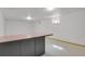 Finished basement featuring a stylish bar area with ample space for various activities and enjoyment at 65 Reed St, Lakewood, CO 80226