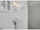A traditional bathroom features a pedestal sink, mirrored cabinet, and step-in shower at 65 Reed St, Lakewood, CO 80226