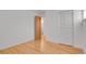Bright bedroom featuring gleaming hardwood floors and a spacious closet for optimal storage at 65 Reed St, Lakewood, CO 80226