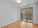 Bright bedroom with hardwood floors and sliding glass doors leading to a small patio at 65 Reed St, Lakewood, CO 80226