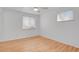 This cozy bedroom features bright hardwood floors, two windows, and neutral walls at 65 Reed St, Lakewood, CO 80226