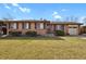 Charming brick home with manicured lawn and attached garage offers great curb appeal at 65 Reed St, Lakewood, CO 80226