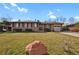 Lovely brick home featuring an attached garage and well-maintained front lawn at 65 Reed St, Lakewood, CO 80226