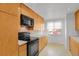 A functional kitchen features wood cabinets, black appliances, and plenty of counter space at 65 Reed St, Lakewood, CO 80226