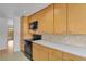 This efficient kitchen features wooden cabinets, sleek black appliances, and ample counter space at 65 Reed St, Lakewood, CO 80226