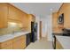 A well-lit kitchen showcases wood cabinets and modern appliances, including a dishwasher and stove at 65 Reed St, Lakewood, CO 80226