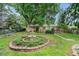 Charming backyard with mature trees, fountain feature, and lush landscaping, creating a private oasis at 5190 W Mexico Ave, Denver, CO 80219