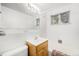 Clean bathroom featuring a white tile shower and single sink vanity at 5190 W Mexico Ave, Denver, CO 80219