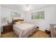 Comfortable bedroom with carpet flooring, ceiling fan, and two windows at 5190 W Mexico Ave, Denver, CO 80219