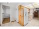 Kitchen area featuring a refrigerator, pantry, and light wood cabinets at 5190 W Mexico Ave, Denver, CO 80219