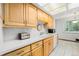 Functional kitchen featuring wood cabinets, white countertops, and tile flooring at 5190 W Mexico Ave, Denver, CO 80219