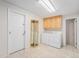Efficient laundry room with tile flooring, ample storage, and adjacent appliances for added convenience at 5190 W Mexico Ave, Denver, CO 80219