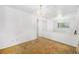 Open living space featuring carpet, a decorative light fixture, and a window at 5190 W Mexico Ave, Denver, CO 80219