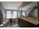 Bright bathroom featuring a freestanding tub, double vanity with quartz countertop, and stylish checkered floors at 2831 N Perry St, Denver, CO 80212