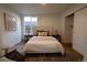 Comfortable bedroom with queen bed, plush rug, closet, and natural light from the window at 2831 N Perry St, Denver, CO 80212