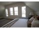 Bedroom showing lots of light from three windows on the side and neutral-colored bedding at 2831 N Perry St, Denver, CO 80212