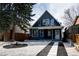 Charming two-story home with modern curb appeal, crisp white trim, and professionally landscaped front yard at 2831 N Perry St, Denver, CO 80212
