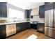 Well-equipped kitchen with stainless appliances, modern cabinetry, and gleaming hardwood floors at 2831 N Perry St, Denver, CO 80212
