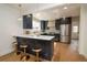 Modern kitchen with stainless steel appliances, center island, and sleek dark cabinetry at 2831 N Perry St, Denver, CO 80212