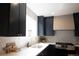 Stylish kitchen featuring stainless appliances, modern cabinetry, and white countertops at 2831 N Perry St, Denver, CO 80212