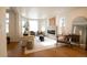 Bright and airy living room with hardwood floors, fireplace, and large windows with natural light at 2831 N Perry St, Denver, CO 80212