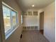 Bright mudroom boasts built-in shelving and bench, large window, brick floor, and access to the backyard at 2831 N Perry St, Denver, CO 80212