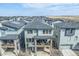 Aerial view of a home with a patio, surrounded by other homes with solar panels, and scenic landscape at 15774 W Girard Ave, Morrison, CO 80465
