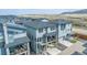 Aerial view of a house with a patio and mountain views in a neighborhood with similar homes at 15774 W Girard Ave, Morrison, CO 80465