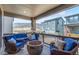 Inviting covered deck with outdoor seating, fire pit, stone pillars, and scenic mountain views at 15774 W Girard Ave, Morrison, CO 80465