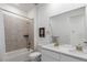 Bright bathroom with a shower-tub combo, double sinks, and tile floors at 15774 W Girard Ave, Morrison, CO 80465