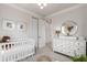 Stylish Bedroom with a crib, dresser/changing table, and ample storage at 15774 W Girard Ave, Morrison, CO 80465