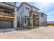 Street view showcasing modern two-story homes with stone accents, balconies, drive-under garages, and well-kept landscaping at 15774 W Girard Ave, Morrison, CO 80465