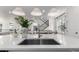Bright kitchen featuring a center island with sink, pendant lighting, stainless appliances, and white cabinetry at 15774 W Girard Ave, Morrison, CO 80465