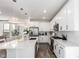 Bright modern kitchen featuring a center island, stainless steel appliances, and sleek white cabinetry at 15774 W Girard Ave, Morrison, CO 80465
