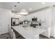 Bright modern kitchen featuring a center island, stainless steel appliances, and sleek white cabinetry at 15774 W Girard Ave, Morrison, CO 80465