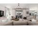 Bright living room features a modern chandelier and sliding glass doors to a private patio at 15774 W Girard Ave, Morrison, CO 80465
