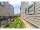 Side yard with well-maintained lawn, landscaping, and a fence separating the properties at 15774 W Girard Ave, Morrison, CO 80465