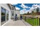 Inviting back deck with black railing, chairs, and beautiful landscaping at 1933 Villageview Ln, Castle Rock, CO 80104