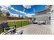 Spacious back deck with black railing, outdoor furniture, and lush green grass at 1933 Villageview Ln, Castle Rock, CO 80104