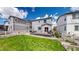 Landscaped backyard featuring a deck, grass, and planter boxes at 1933 Villageview Ln, Castle Rock, CO 80104