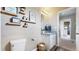 Bright bathroom featuring vanity with decor and decorative wood shelves at 1933 Villageview Ln, Castle Rock, CO 80104